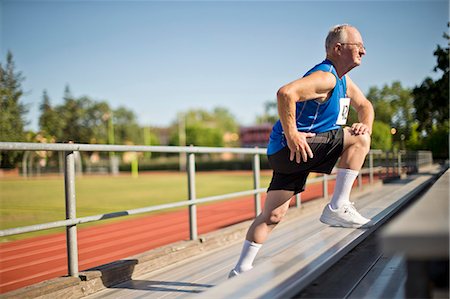 Senior man stretching before a race at a sports track. Stock Photo - Premium Royalty-Free, Code: 6128-08727899