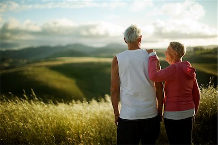 Senior couple looking out at a rural landscape while exercising together. Stock Photo - Premium Royalty-Free, Code: 6128-08727813