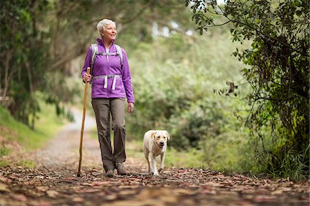 dog - Mature woman on a rural hike with her dog. Stock Photo - Premium Royalty-Free, Code: 6128-08727997