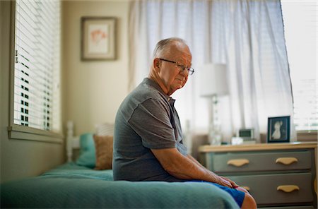photographic print - Lonely senior man sitting on his bed in a rest home. Stock Photo - Premium Royalty-Free, Code: 6128-08727902
