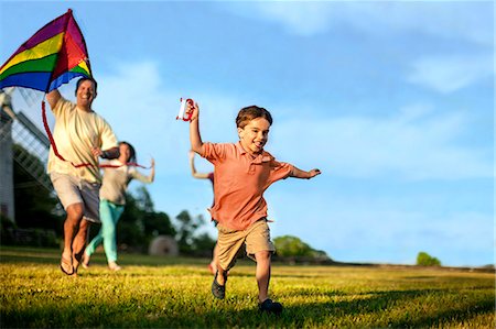 running family grass - Little boy flying a kite with his parents. Stock Photo - Premium Royalty-Free, Code: 6128-08728064