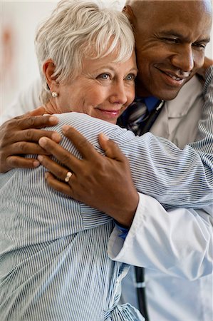 doctor hugging a person - Cheerful mature woman thanks her doctor by giving him a hug. Stock Photo - Premium Royalty-Free, Code: 6128-08728010