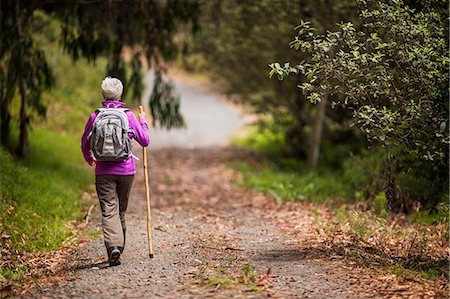 elderly lady back - Mature woman goes for a hike along a leafy forest trail. Stock Photo - Premium Royalty-Free, Code: 6128-08728019