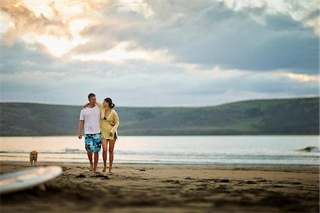 pictures of people walking with surfboards in the water - Middle aged couple walking together on the beach. Stock Photo - Premium Royalty-Free, Code: 6128-08728184
