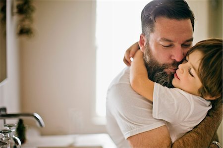 Father hugging and kissing his young son. Stock Photo - Premium Royalty-Free, Code: 6128-08728218