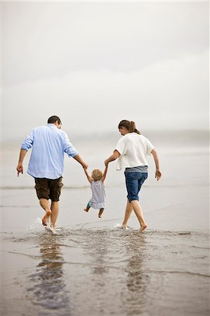 simsearch:700-01582158,k - Couple walking hand in hand with their daughter on a beach at low tide. Stock Photo - Premium Royalty-Free, Code: 6128-08737692