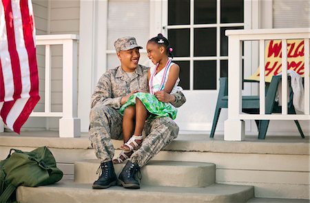 Happy young girl and her father sitting together on the front porch of their home. Stock Photo - Premium Royalty-Free, Code: 6128-08737841