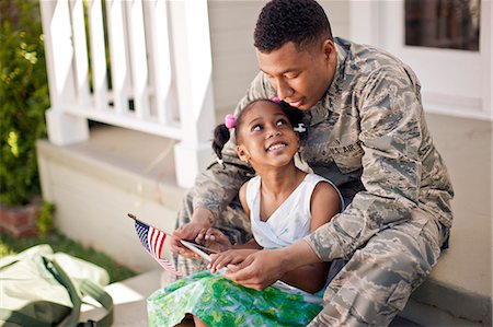 soldier with family - Happy young girl looking up at her father as they sit together on their porch. Photographie de stock - Premium Libres de Droits, Code: 6128-08737857