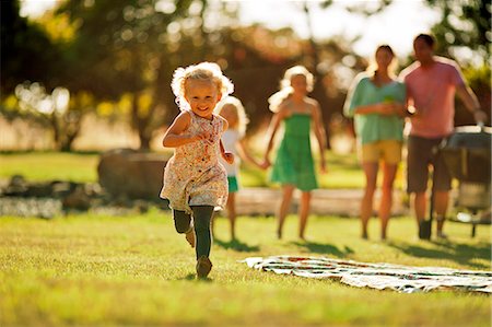 preschool girl - Happy siblings playing in their backyard. Stock Photo - Premium Royalty-Free, Code: 6128-08737880