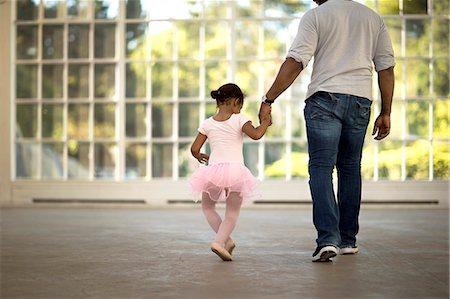 Mid adult man holding the hand of his young daughter. Stock Photo - Premium Royalty-Free, Code: 6128-08737990