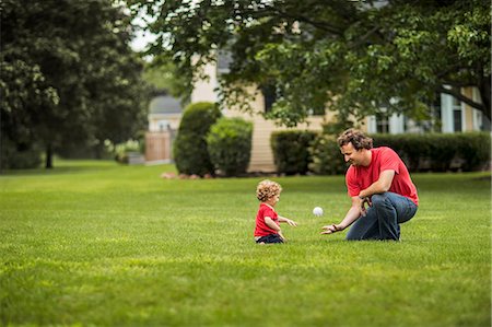 projecting - Mid adult man showing his young son how to catch a baseball. Stock Photo - Premium Royalty-Free, Code: 6128-08737998