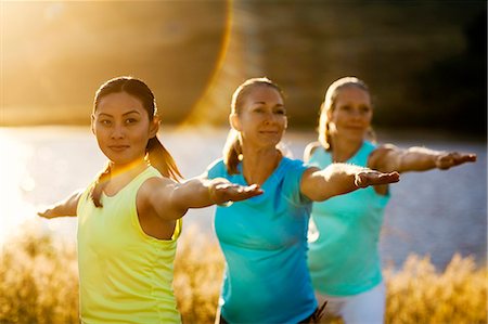 simsearch:6128-08825413,k - Three women practicing yoga in a rural field. Stock Photo - Premium Royalty-Free, Code: 6128-08738442