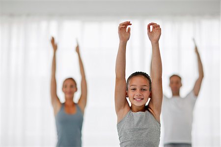 simsearch:6128-08825413,k - Portrait of a young girl stretching while doing yoga. Stock Photo - Premium Royalty-Free, Code: 6128-08738432