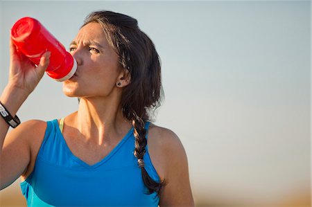 simsearch:6113-07790833,k - Mid adult woman enjoying a drink after working out. Stock Photo - Premium Royalty-Free, Code: 6128-08738528