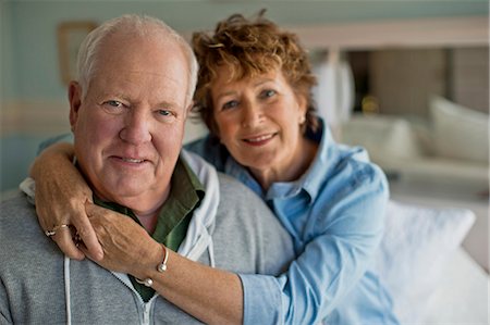 simsearch:600-06752300,k - Portrait of a cheerful mature couple smiling happily as they sit in their home. Stock Photo - Premium Royalty-Free, Code: 6128-08738605