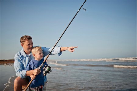 simsearch:6109-06003758,k - Happy father and son fishing at low tide on a beach. Stock Photo - Premium Royalty-Free, Code: 6128-08840967