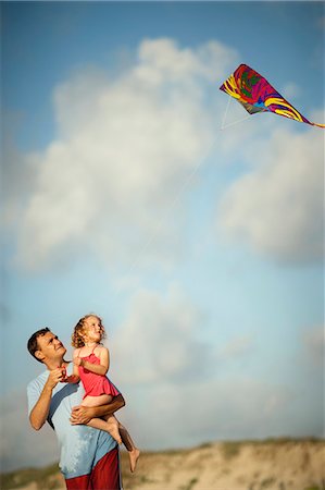 family beach kites - Man and his daughter playing with a kite at the beach. Stock Photo - Premium Royalty-Free, Code: 6128-08840969