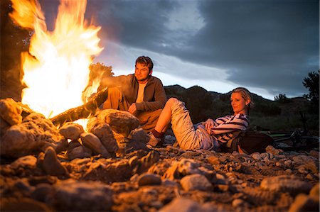 simsearch:649-09078617,k - Content young couple sitting by a glowing campfire. Stock Photo - Premium Royalty-Free, Code: 6128-08840972