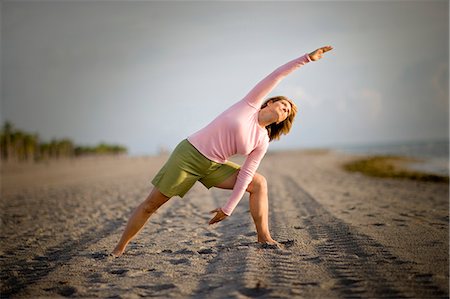 simsearch:633-01714467,k - Mid-adult woman doing yoga on a beach. Stock Photo - Premium Royalty-Free, Code: 6128-08840904
