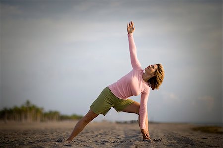simsearch:633-01714467,k - Mid-adult woman doing yoga on a beach. Stock Photo - Premium Royalty-Free, Code: 6128-08840905