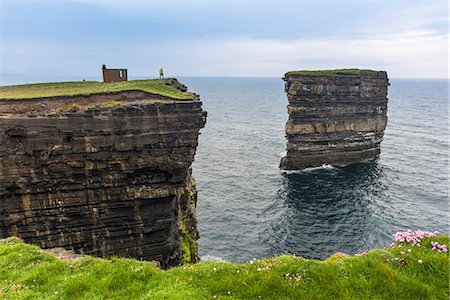 Downpatrick Head, Ballycastle, County Mayo, Donegal, Connacht region, Ireland, Europe. A man watching the sea stack from the top of the cliff. Stock Photo - Premium Royalty-Free, Code: 6129-09044480