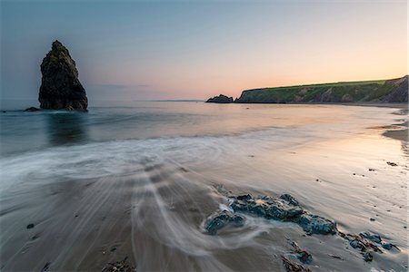 Ballydowane Cove, County Waterford, Munster province, Ireland, Europe. The sea stack in the ocean with the high tide. Stock Photo - Premium Royalty-Free, Code: 6129-09044522