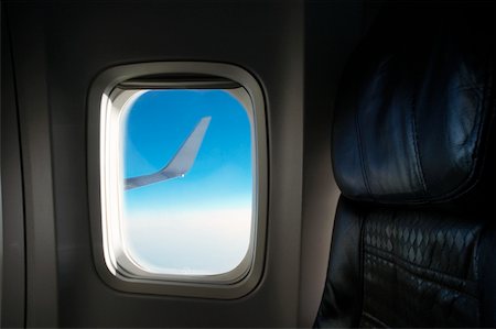 Airplane wing seen through an airplane window Stock Photo - Premium Royalty-Free, Code: 625-00805078