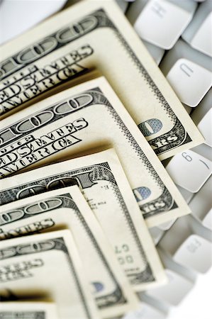 simsearch:625-00801281,k - United States one hundred dollar bills on top of computer keyboard close-up Stock Photo - Premium Royalty-Free, Code: 625-00801104
