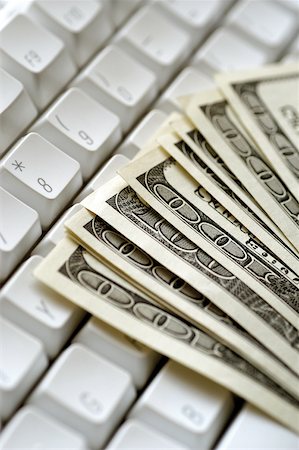 simsearch:625-00801281,k - United States one hundred dollar bills on top of computer keyboard close-up Stock Photo - Premium Royalty-Free, Code: 625-00801120