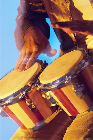 percussion instrument - Mid section view of a musician playing the bongo Stock Photo - Premium Royalty-Free, Code: 625-00802855