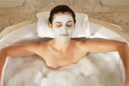 simsearch:633-06354677,k - High angle view of a young woman in a bubble bath with her eyes closed Stock Photo - Premium Royalty-Free, Code: 625-00837820