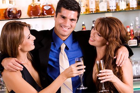 simsearch:625-00902698,k - Portrait of a businessman with his arms around a young woman and a mid adult woman Foto de stock - Sin royalties Premium, Código: 625-00838315
