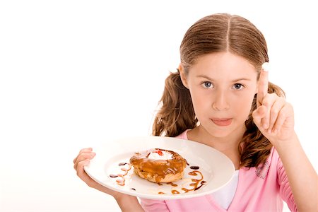 simsearch:625-01250196,k - Portrait of a girl holding a donut in a plate with cream on the tip of her finger Stock Photo - Premium Royalty-Free, Code: 625-00838597