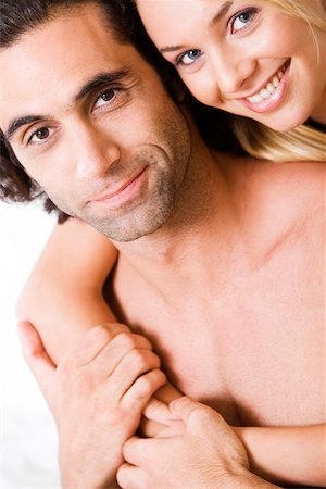 simsearch:625-00850507,k - Portrait of a young woman embracing a young man from behind Stock Photo - Premium Royalty-Free, Code: 625-00839141