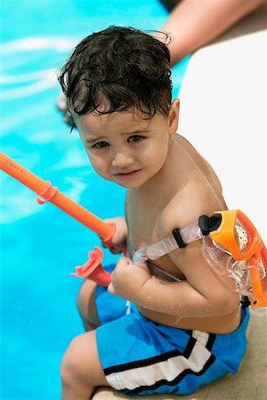 simsearch:625-01748893,k - High angle view of a boy holding snorkel sitting by the pool Stock Photo - Premium Royalty-Free, Code: 625-00849898