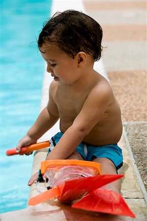 simsearch:625-01748893,k - Close-up of a boy sitting by the pool Stock Photo - Premium Royalty-Free, Code: 625-00849943