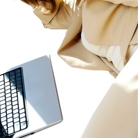 simsearch:625-00801205,k - Mid section view of a businesswoman lying in front of a laptop Stock Photo - Premium Royalty-Free, Code: 625-00840881