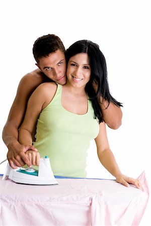 simsearch:625-00850507,k - Young woman ironing with a young man embracing her from behind Stock Photo - Premium Royalty-Free, Code: 625-00841283