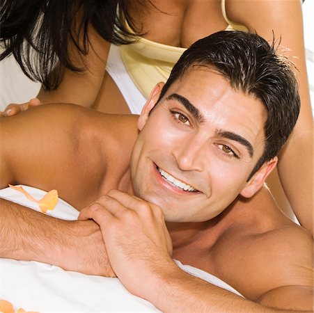simsearch:625-00850507,k - Mid adult woman massaging a mid adult man's shoulders on the bed Stock Photo - Premium Royalty-Free, Code: 625-00842247