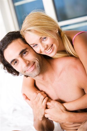 simsearch:625-00850507,k - Portrait of a young woman embracing a young man from behind Stock Photo - Premium Royalty-Free, Code: 625-00843215
