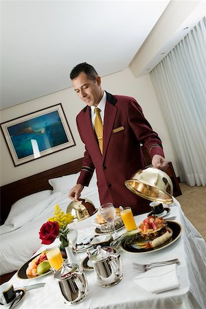 room service - Waiter serving food Stock Photo - Premium Royalty-Free, Code: 625-00850018