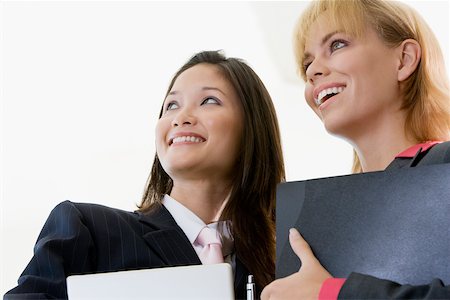 simsearch:625-01097830,k - Low angle view of two businesswomen smiling Stock Photo - Premium Royalty-Free, Code: 625-00850166