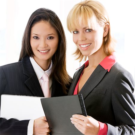 simsearch:625-01097830,k - Portrait of two businesswomen smiling Stock Photo - Premium Royalty-Free, Code: 625-00850197