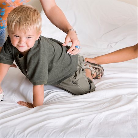 Boy crawling on a bed Stock Photo - Premium Royalty-Free, Code: 625-00850251