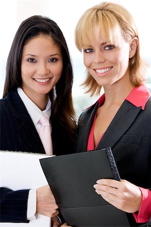 simsearch:625-01097830,k - Portrait of two businesswomen smiling Stock Photo - Premium Royalty-Free, Code: 625-00850764