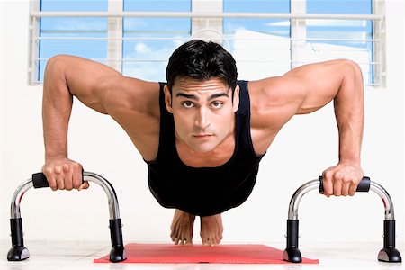 Portrait of a mid adult man doing push-ups Stock Photo - Premium Royalty-Free, Code: 625-00851020