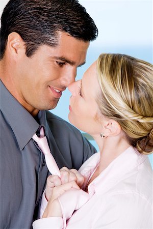 simsearch:625-01092421,k - Close-up of a businesswoman adjusting a businessman's tie Stock Photo - Premium Royalty-Free, Code: 625-00851035