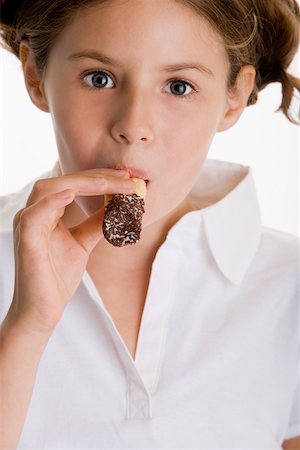 simsearch:625-01250196,k - Portrait of a girl eating a pastry Stock Photo - Premium Royalty-Free, Code: 625-00851188