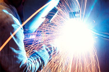 Side profile of a welder welding metal, Chicago, Illinois, USA Stock Photo - Premium Royalty-Free, Code: 625-00898599