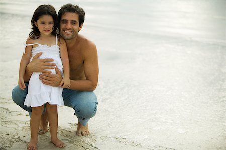 Portrait of a father holding his daughter on the beach Stock Photo - Premium Royalty-Free, Code: 625-00899707